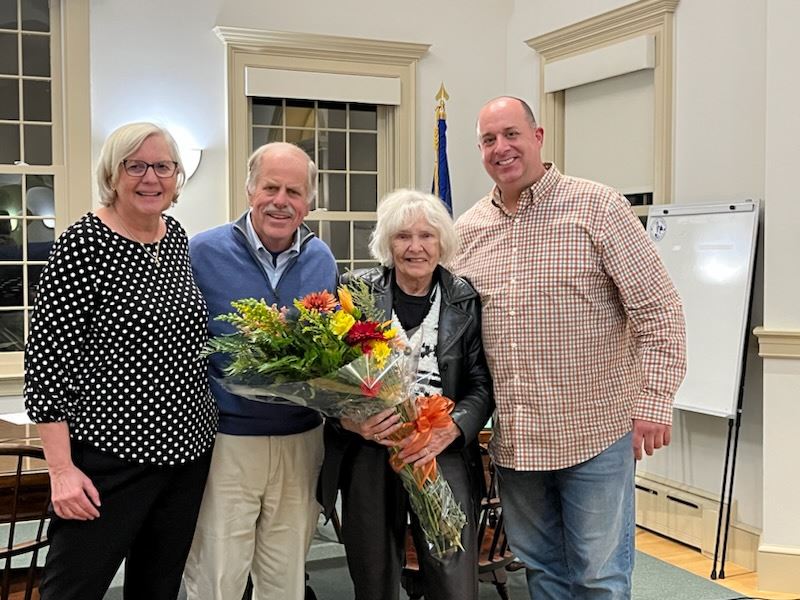 Martha Shoemaker, Tim Griswold, Judy Tooker and Matt Ward presenting Judy flowers on her retirement